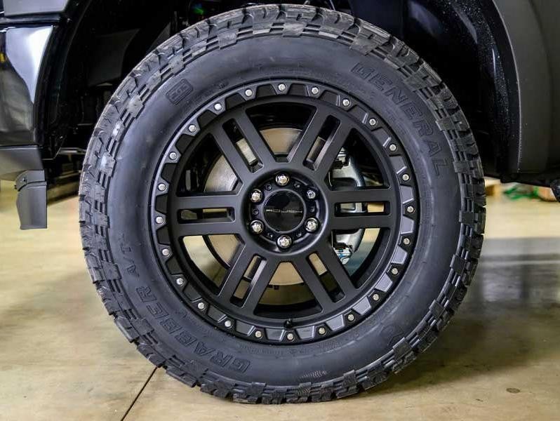 Ford Roush F-150-exterior tires on black truck side view upclose
